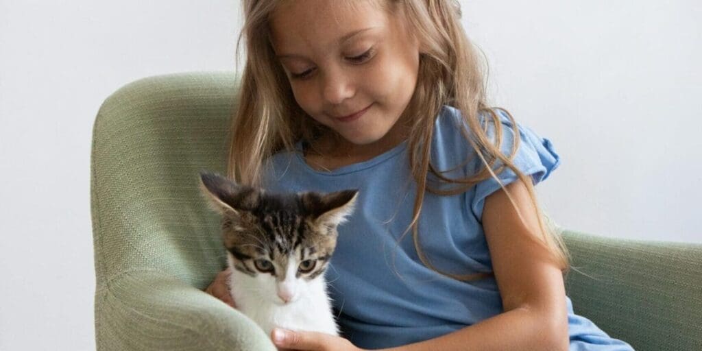 Young Girl Sitting on Chair with Her Cat - Great Family Pets